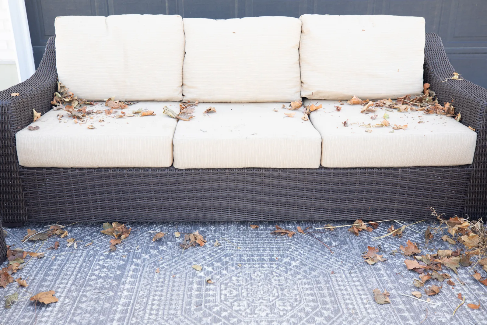 patio furniture with leaves and a rug