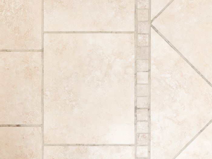 close up, top down view of a beige tile floor with newly cleaned grout lines from Zerorez