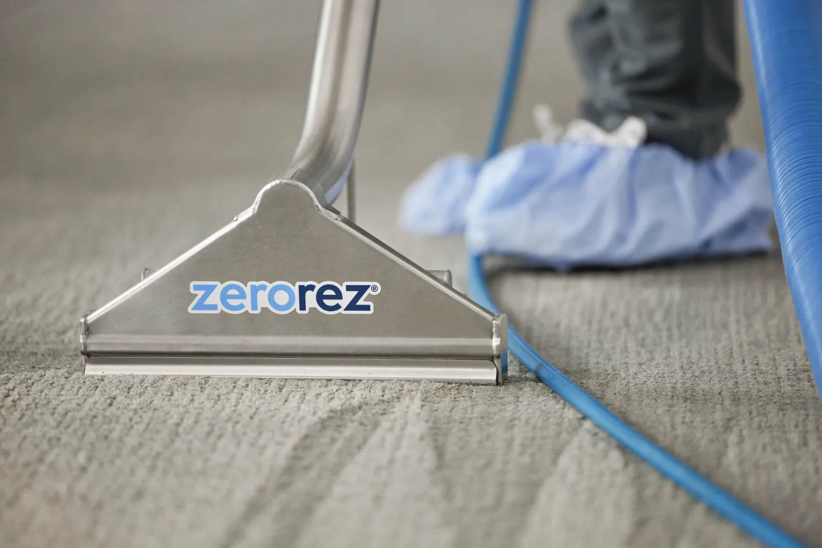 carpet cleaning wand on gray carpet in home